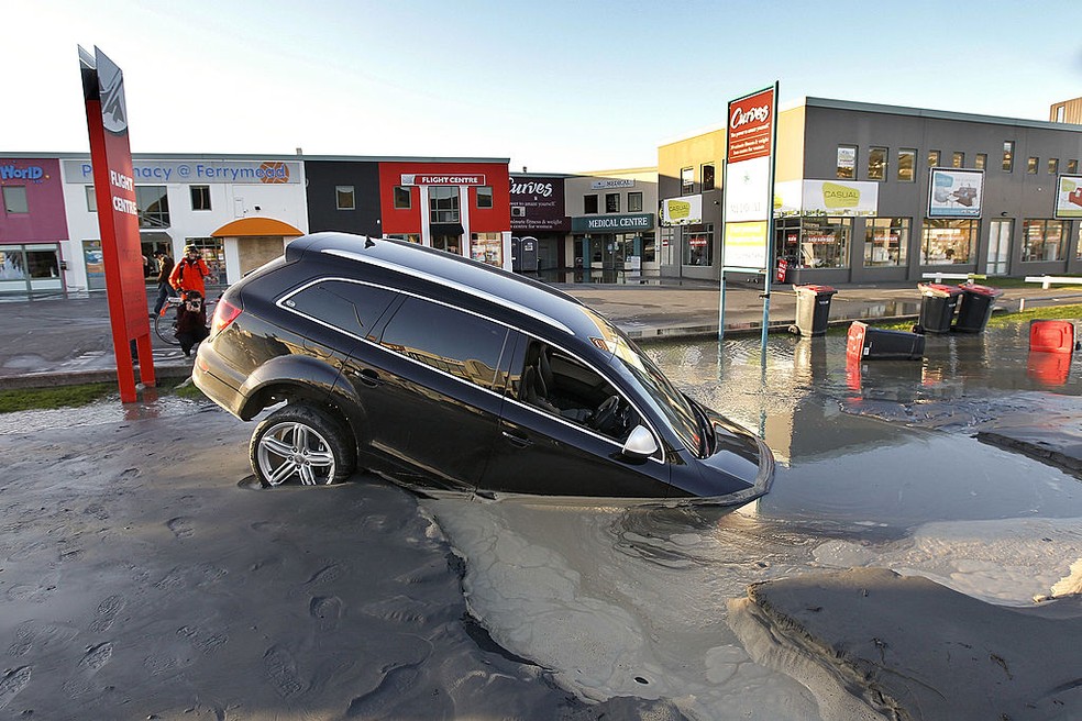 Um carro preso em solo afundado após dois terremotos de magnitude 6,0 e 5,5 em 13 de junho de 2011 em Christchurch, Nova Zelândia. — Foto: Getty Images